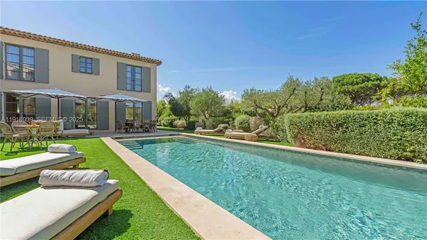 a swimming pool with outdoor seating and yard