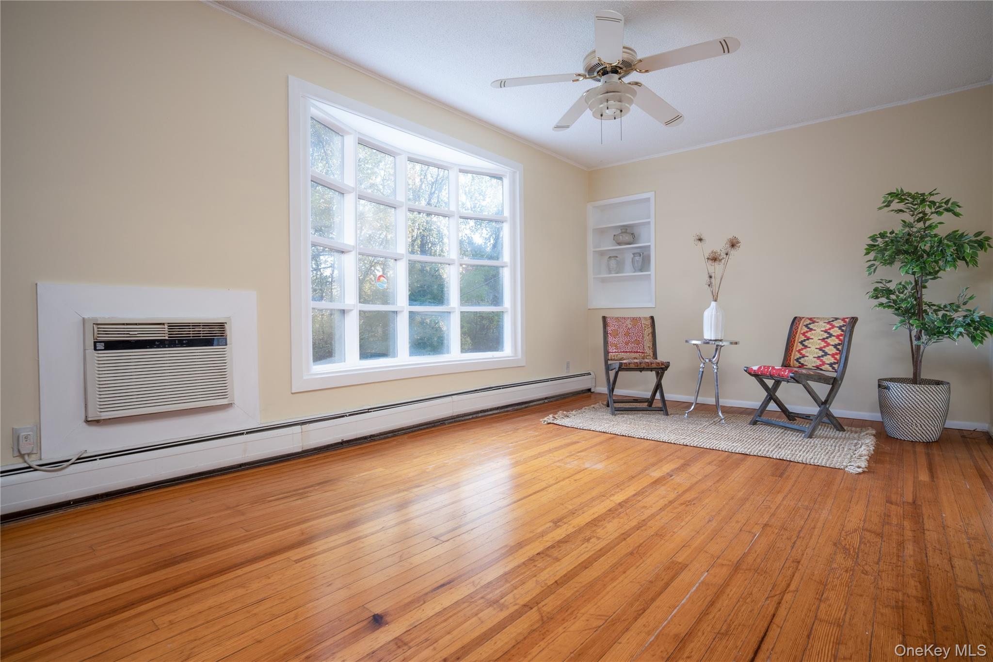 551 South Pascack Road Spring Valley, NY 10977 - Photo 16 of 31 a view of a livingroom with wooden floor and a ceiling fan