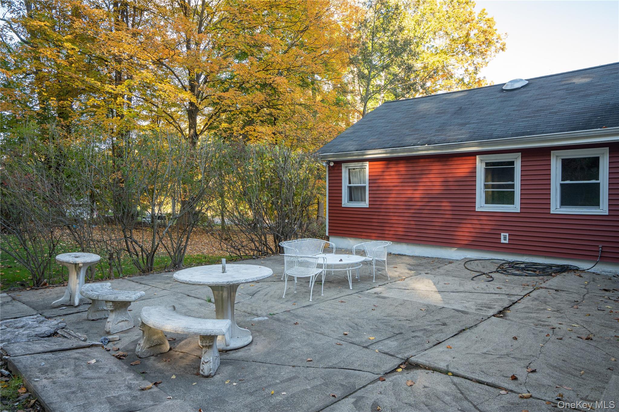 551 South Pascack Road Spring Valley, NY 10977 - Photo 29 of 31 a view of a backyard with table and chairs potted plants and a large tree