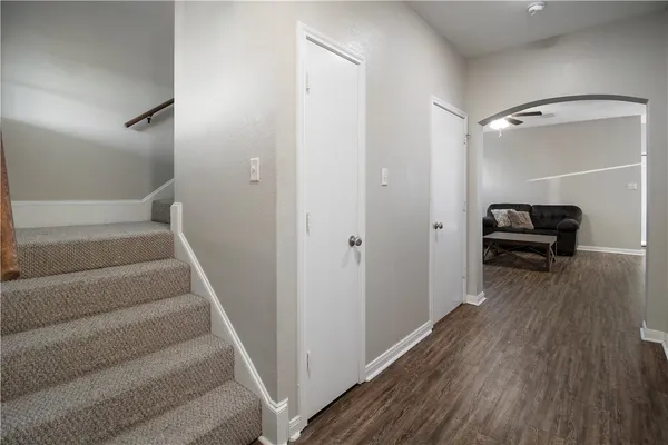 a view of a hallway with wooden floor and staircase