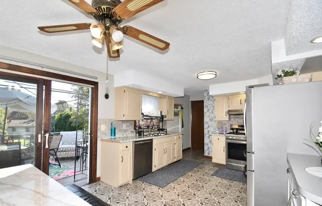 a kitchen with a sink stainless steel appliances and white cabinets