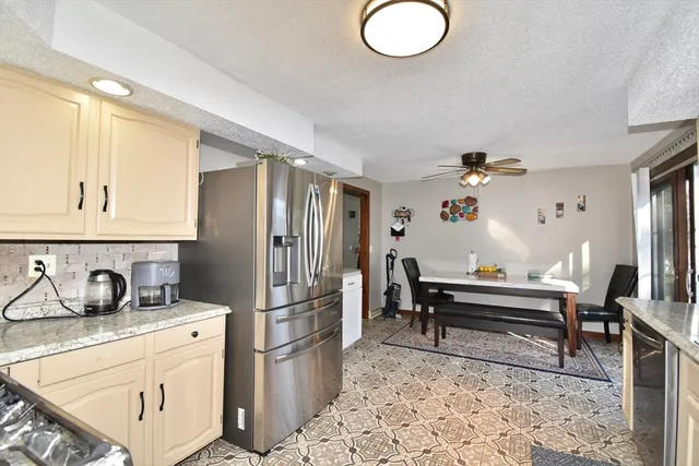 a kitchen with a refrigerator and a sink