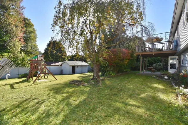 a backyard of a house with table and chairs