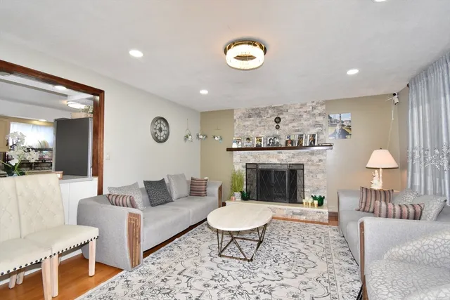 a living room with furniture a table and a fireplace