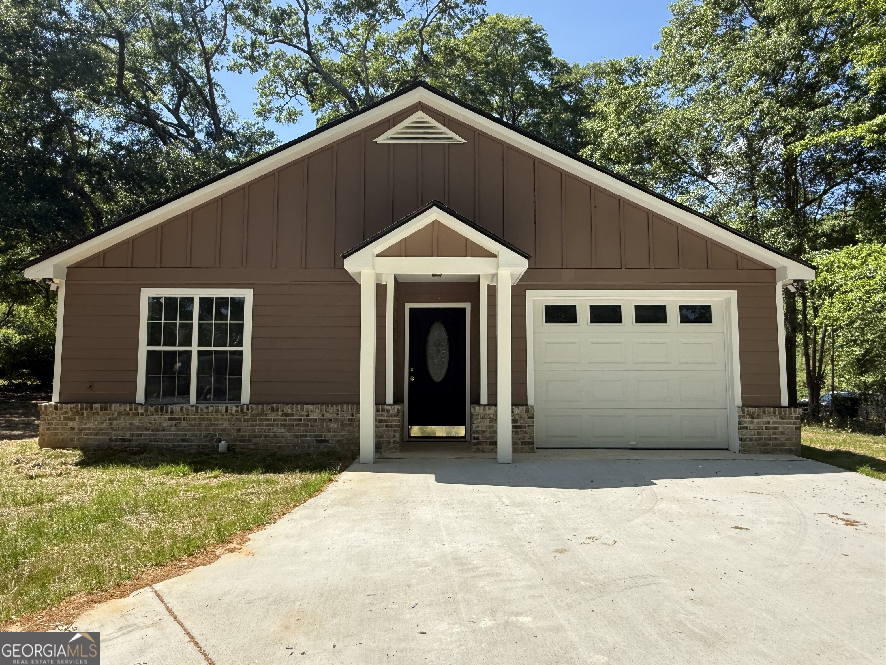 a front view of a house with a yard and garage