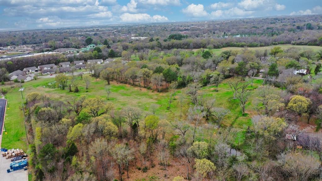 504 Wood Street Athens, TX 75751 - Photo 8 of 13 a view of a lush green forest with trees and some houses