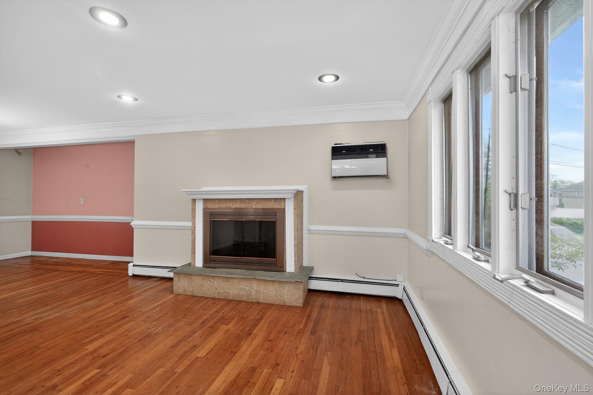 138 Spring Street Massapequa, NY 11758 - Photo 9 of 45 a view of an empty room with wooden floor and a window