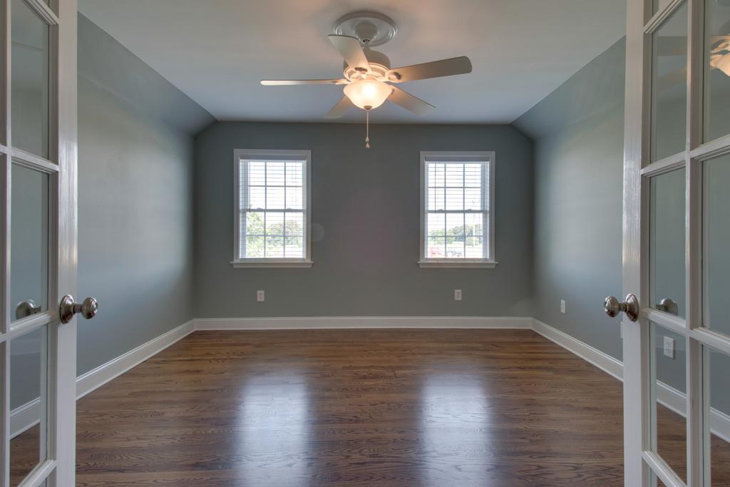 3615 Gunn Road Springfield, TN 37172 - Photo 17 of 30 an empty room with wooden floor chandelier fan and windows