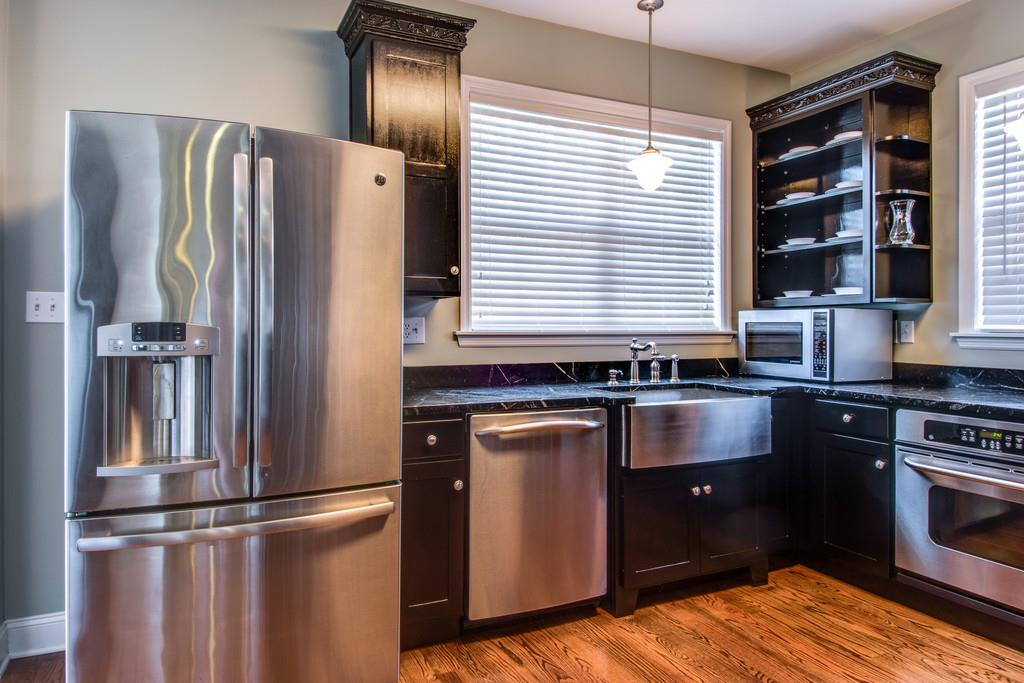 3615 Gunn Road Springfield, TN 37172 - Photo 8 of 30 a kitchen with granite countertop stainless steel appliances and wooden floor