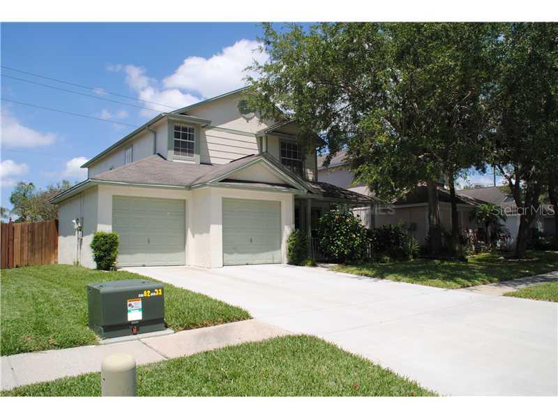 8558 Manassas Road Tampa, FL 33635 - Photo 1 of 1 a front view of a house with a yard and garage