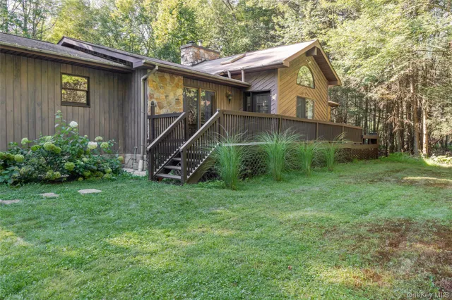 a view of backyard of house with green space