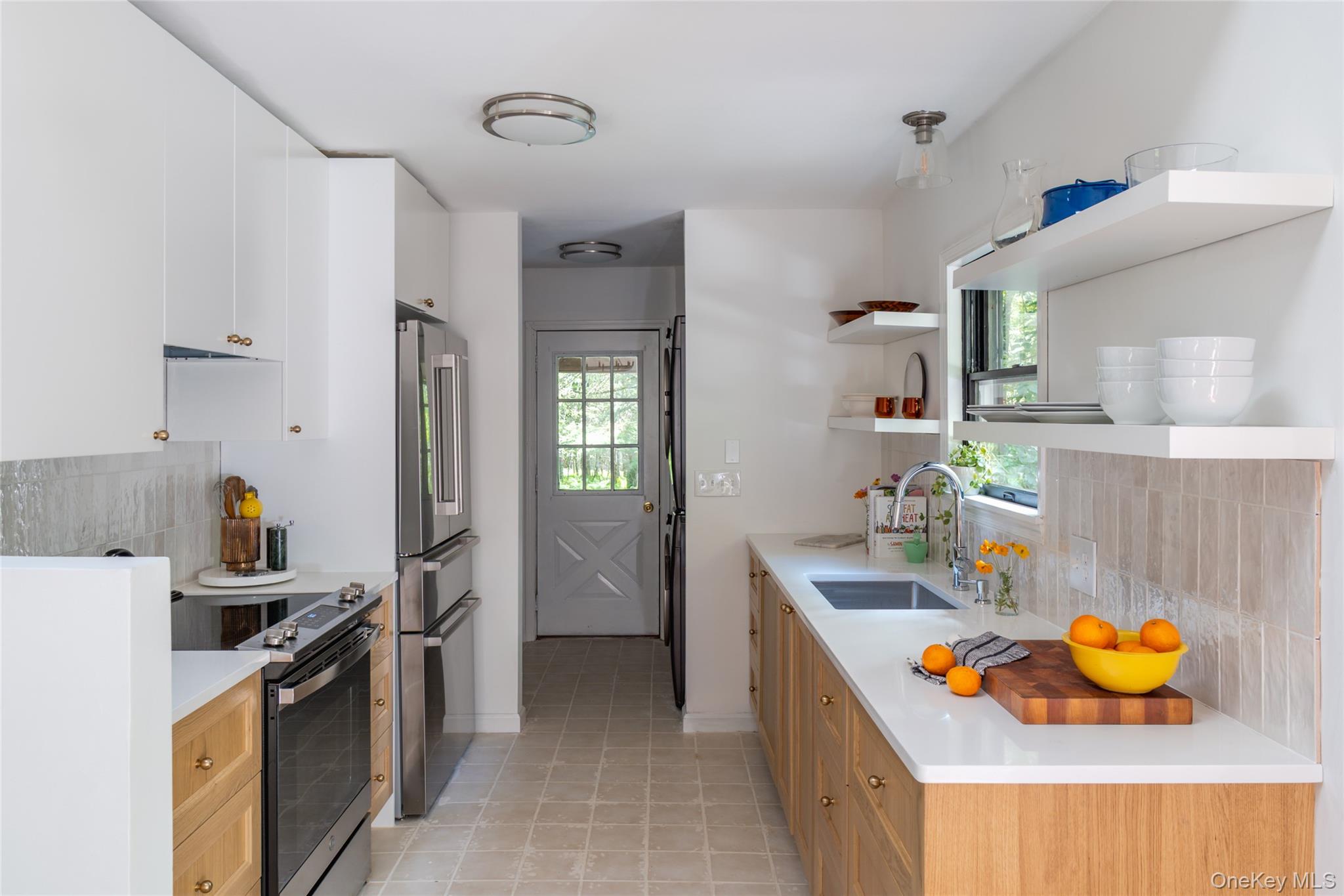 15 Deer Meadow Road Bethel, NY 12720 - Photo 12 of 41 Kitchen featuring backsplash, electric stove, open shelves, freestanding refrigerator, and healthy amount of natural light