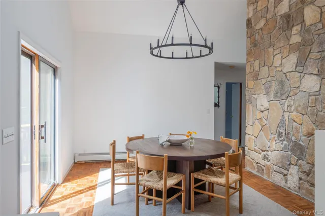 a view of a dining room with furniture wooden floor and chandelier