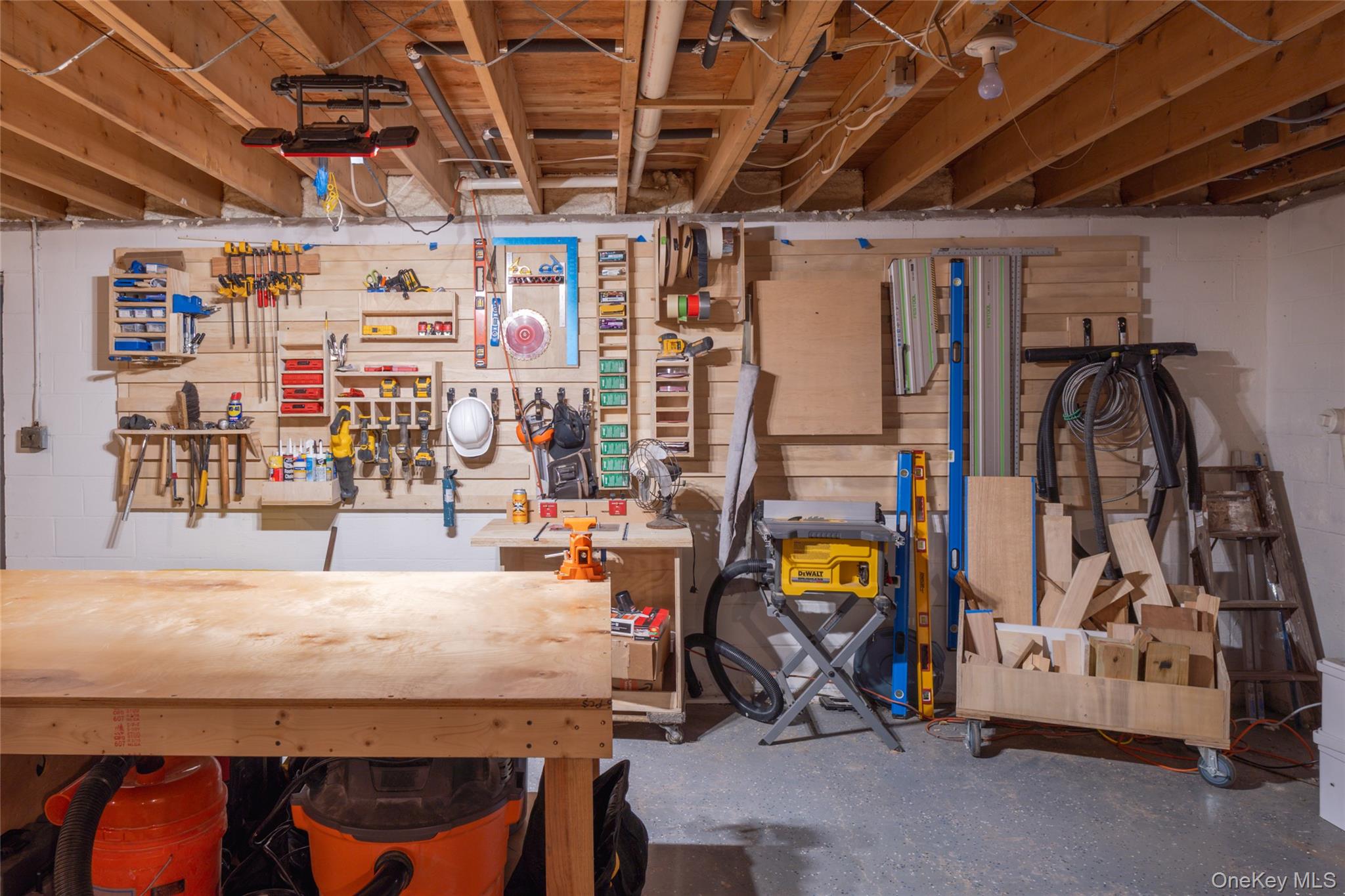 15 Deer Meadow Road Bethel, NY 12720 - Photo 28 of 41 Unfinished basement featuring concrete block wall and a workshop area