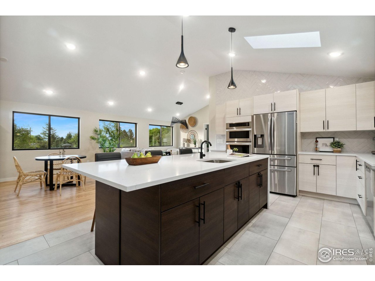 8861 Marathon Road Niwot, CO 80503 - Photo 12 of 40 a kitchen with stainless steel appliances kitchen island a sink table and chairs