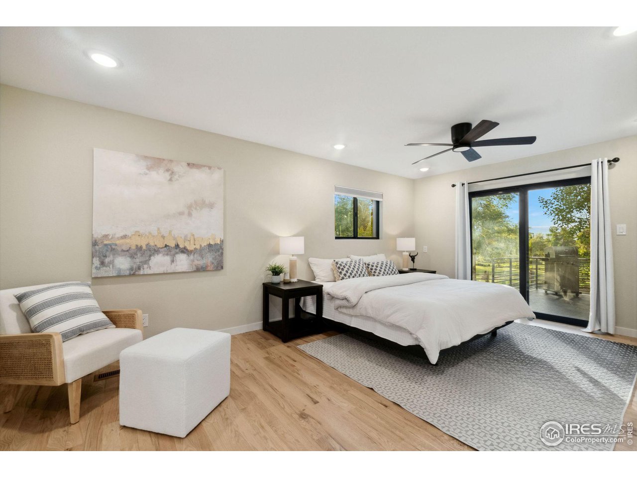 8861 Marathon Road Niwot, CO 80503 - Photo 18 of 40 a spacious bedroom with a bed and a couch