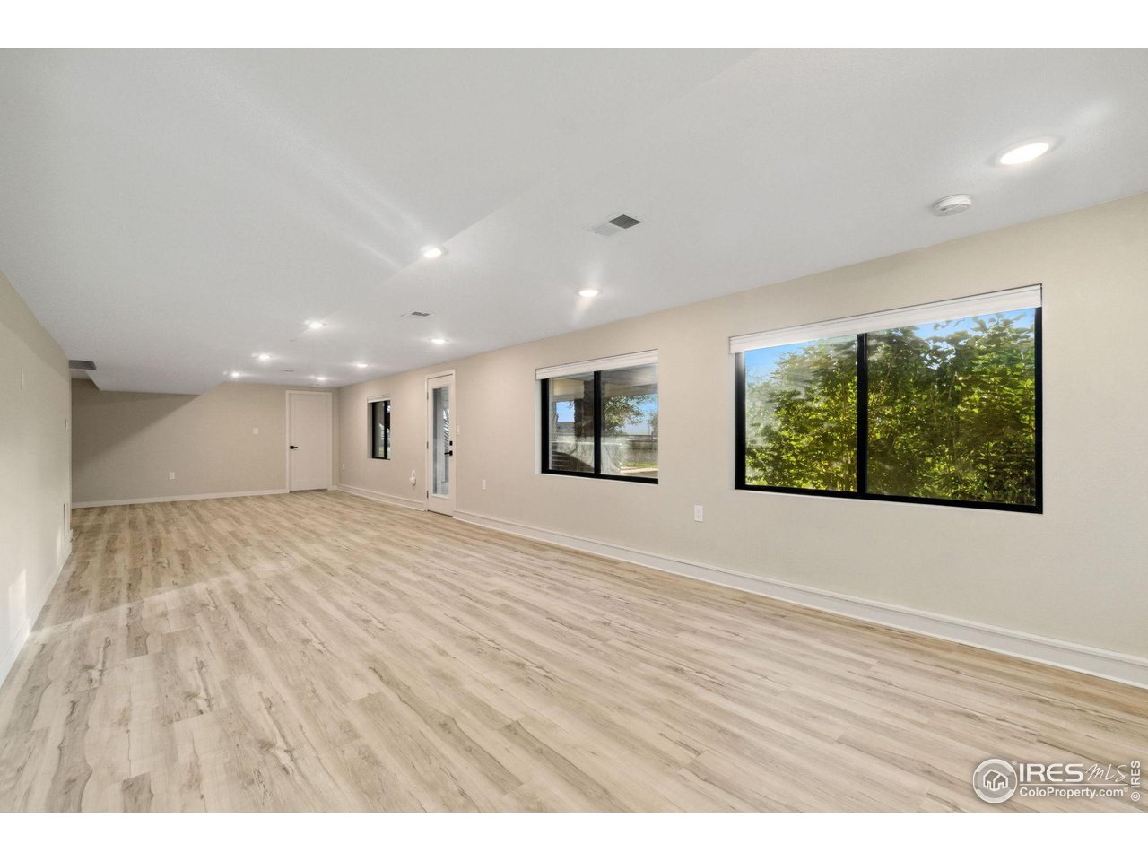 8861 Marathon Road Niwot, CO 80503 - Photo 28 of 40 a view of an empty room with wooden floor and a window