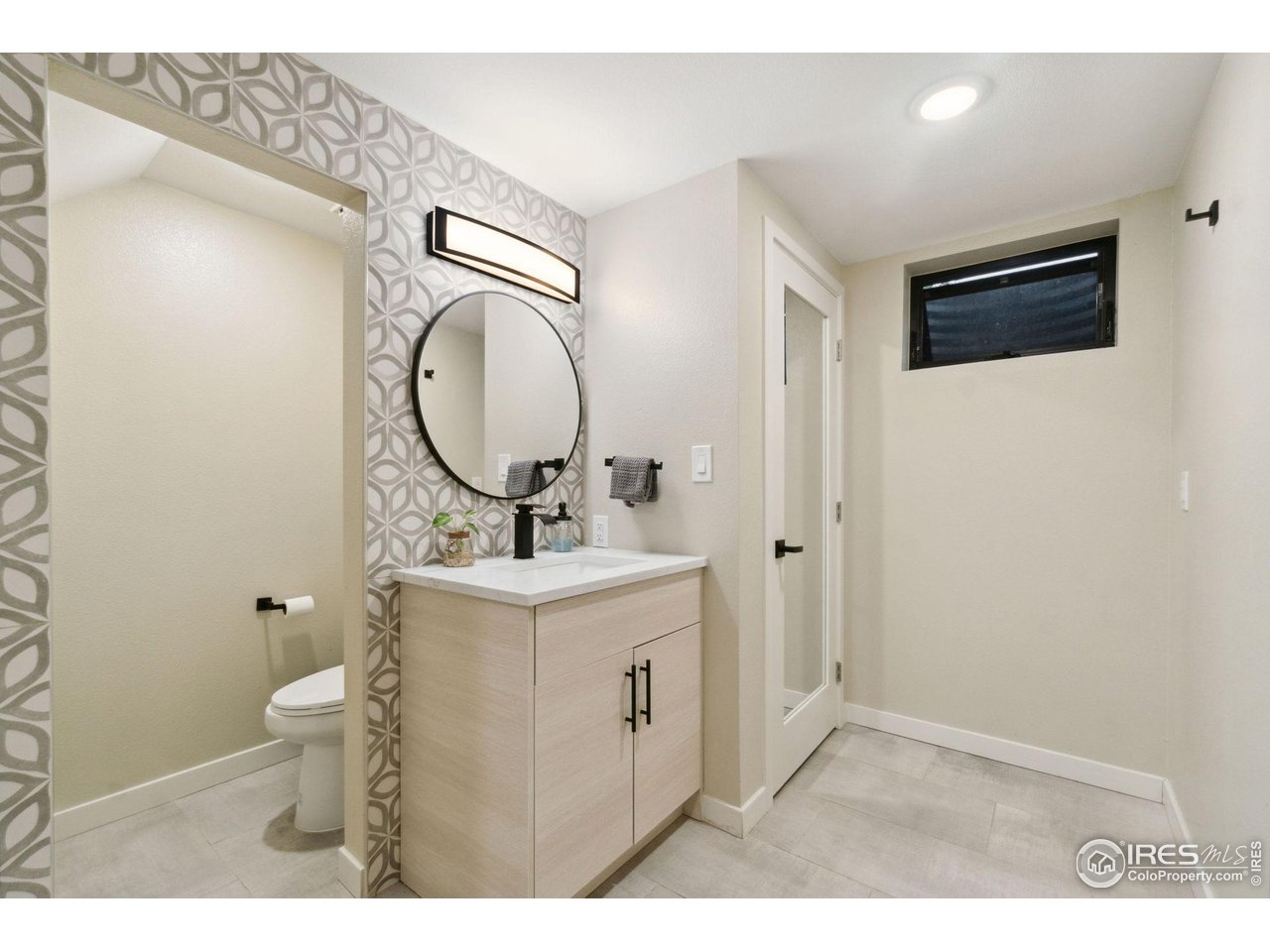 8861 Marathon Road Niwot, CO 80503 - Photo 30 of 40 a bathroom with a toilet sink vanity and mirror