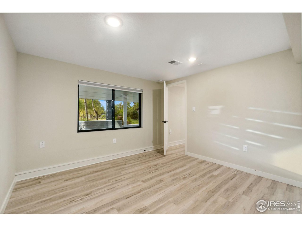 8861 Marathon Road Niwot, CO 80503 - Photo 34 of 40 a view of an empty room with wooden floor and window