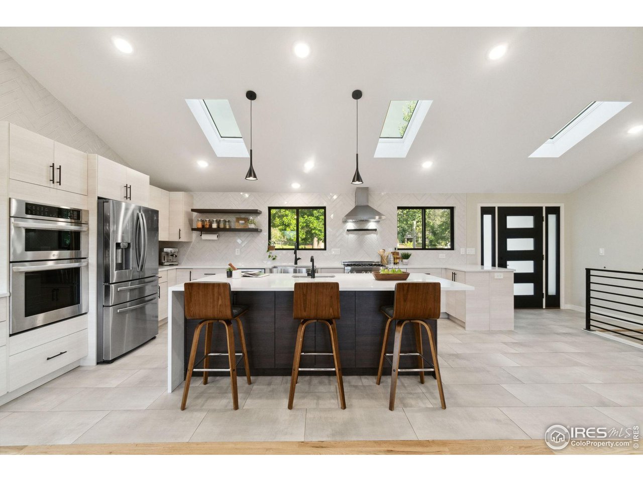 8861 Marathon Road Niwot, CO 80503 - Photo 6 of 40 a kitchen with stainless steel appliances kitchen island granite countertop a table chairs sink and window