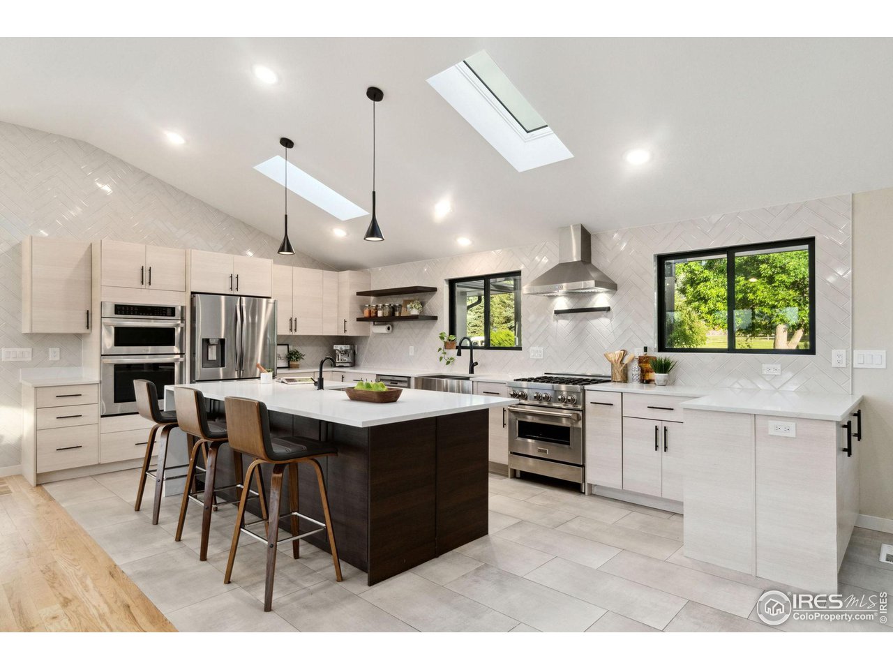 8861 Marathon Road Niwot, CO 80503 - Photo 8 of 40 a kitchen with kitchen island a sink a stove a center island and a window