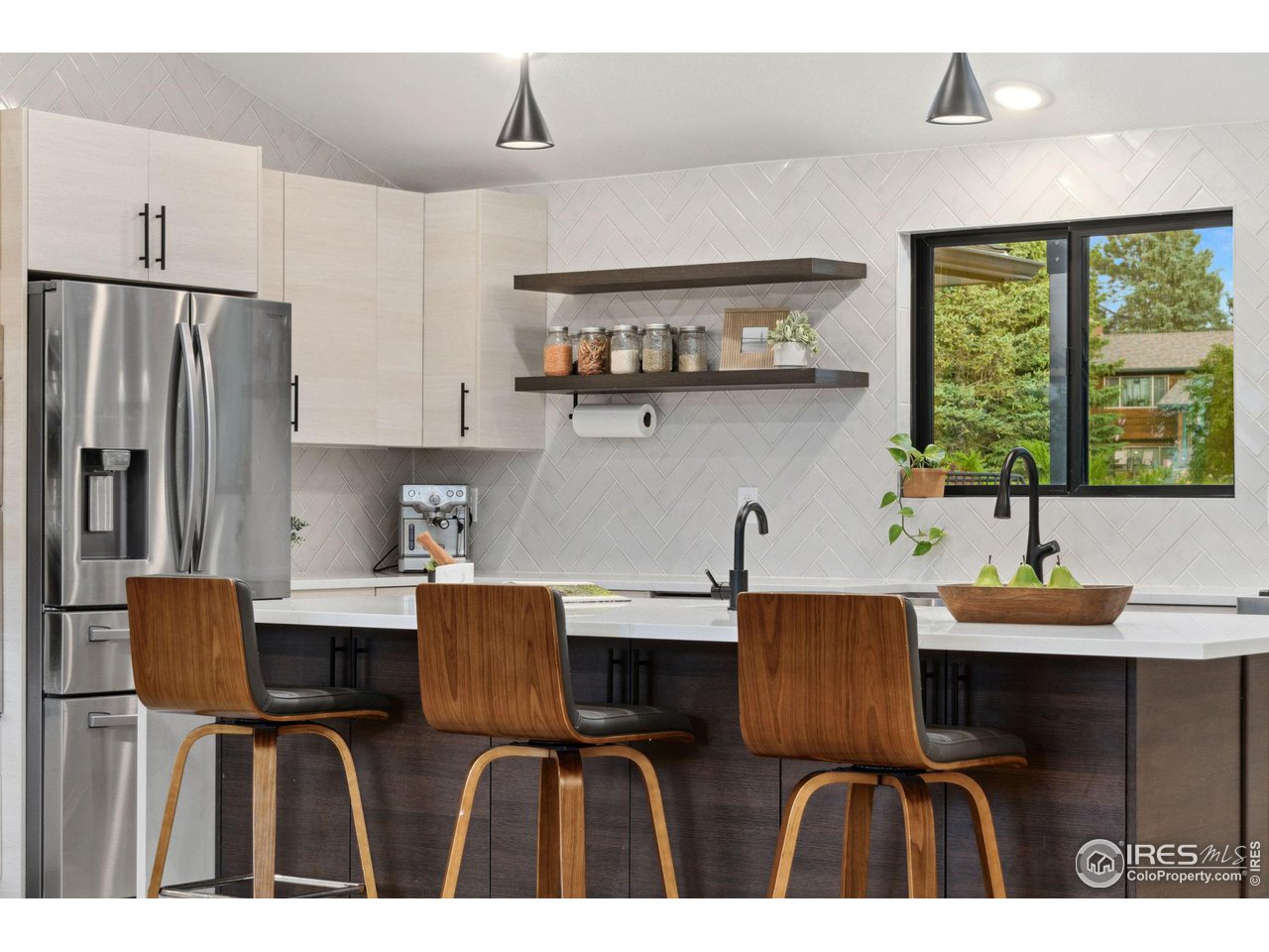 8861 Marathon Road Niwot, CO 80503 - Photo 9 of 40 a kitchen with stainless steel appliances kitchen island granite countertop a sink and cabinets