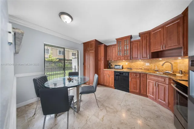a kitchen with granite countertop a sink cabinets and window