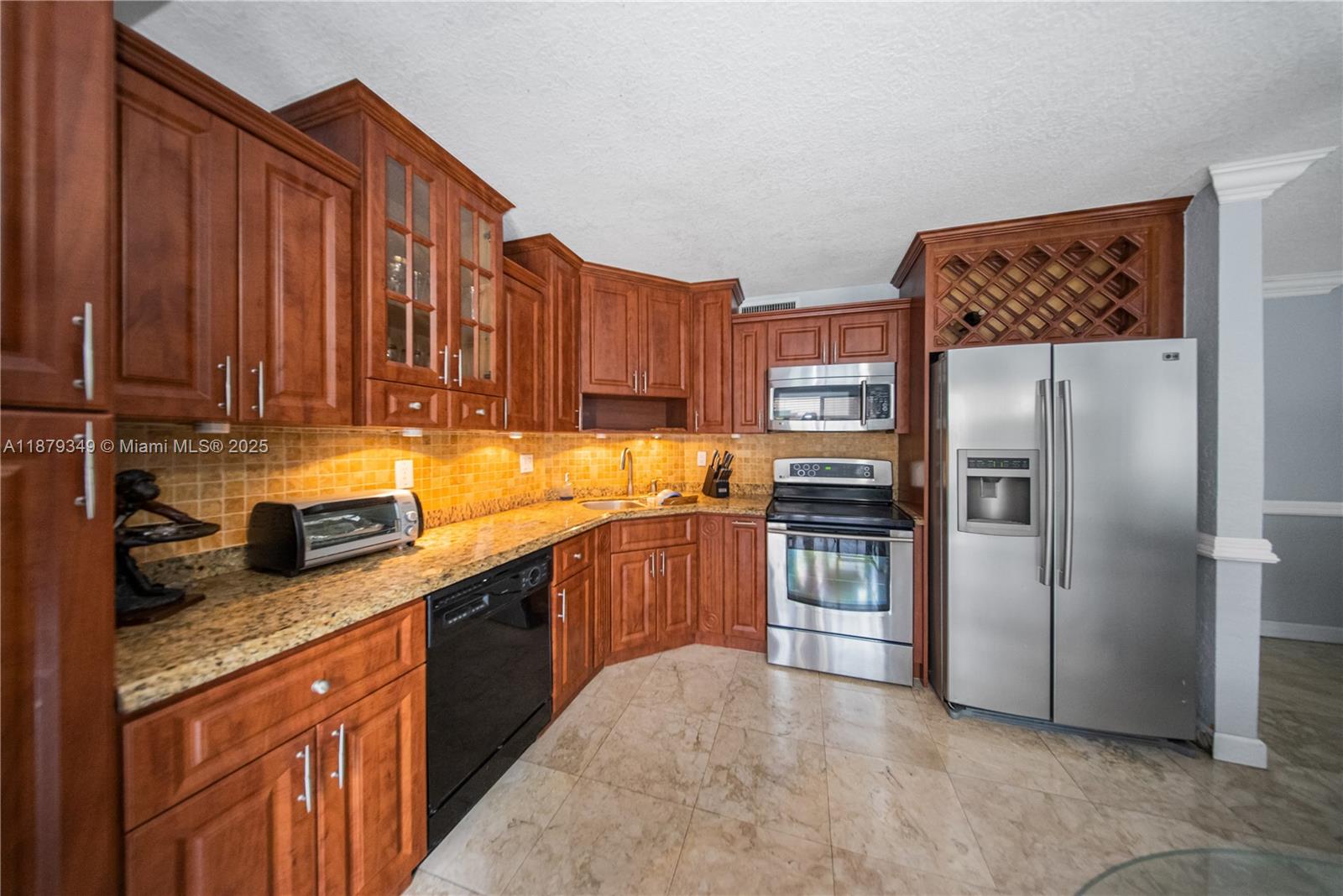 13045 Southwest 68th Street, Unit 103 Miami, FL 33183 - Photo 6 of 13 a kitchen with stainless steel appliances granite countertop a refrigerator a stove and a sink