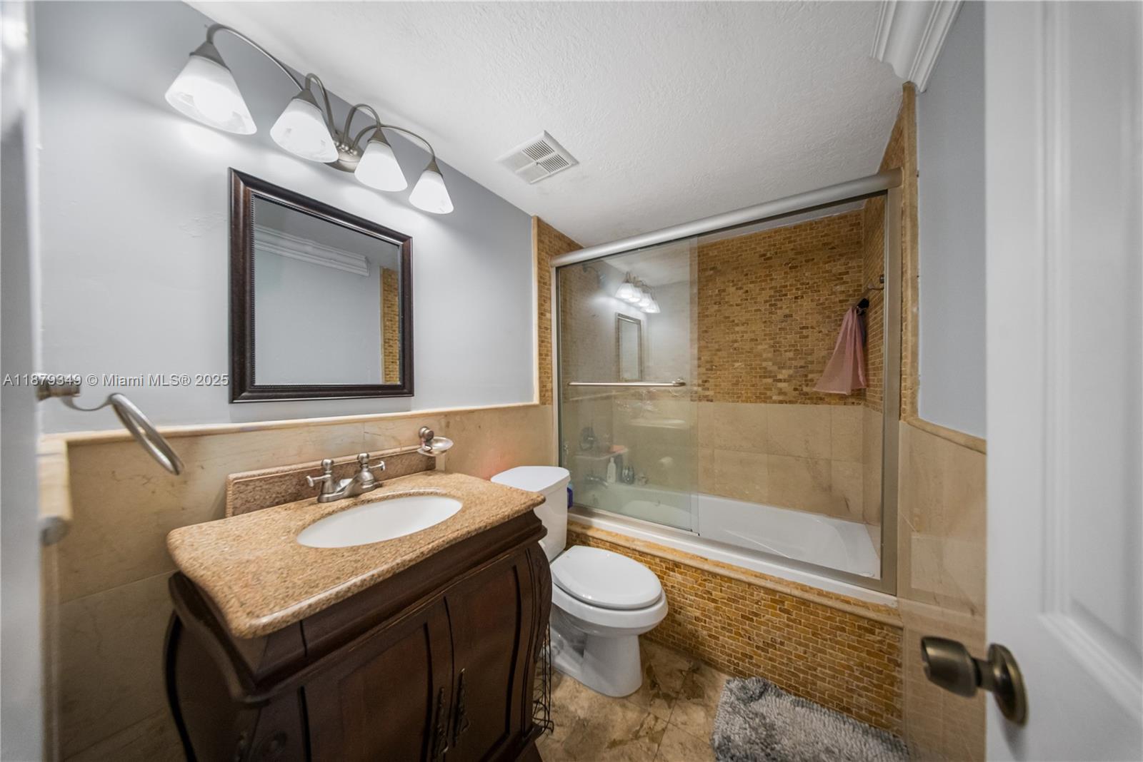 13045 Southwest 68th Street, Unit 103 Miami, FL 33183 - Photo 9 of 13 a bathroom with a sink toilet and shower