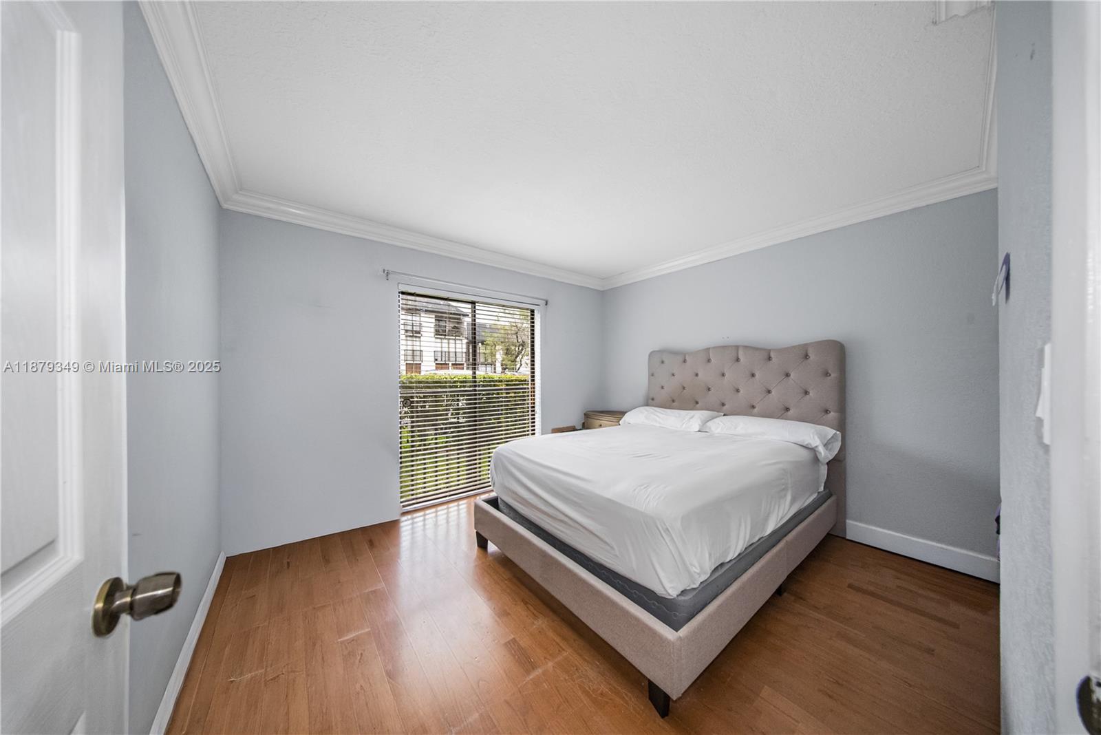 13045 Southwest 68th Street, Unit 103 Miami, FL 33183 - Photo 10 of 13 a bedroom with a bed and window