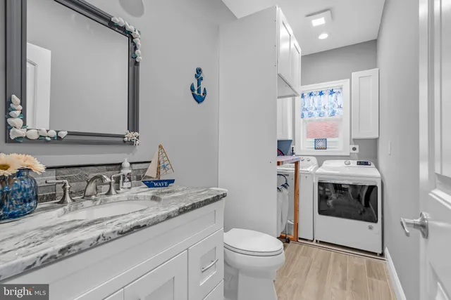 a bathroom with a sink toilet and a mirror