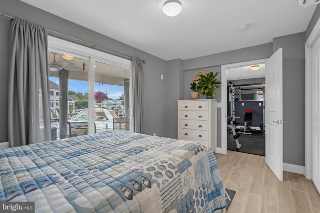 a large bedroom with a bed and a large mirror