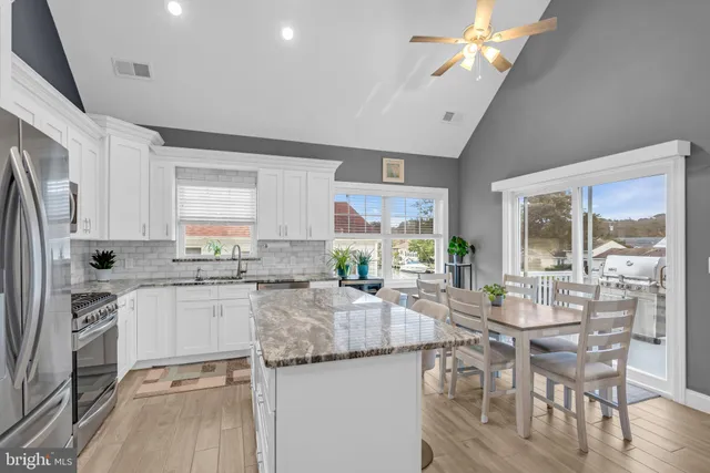 a kitchen with center island and stainless steel appliances