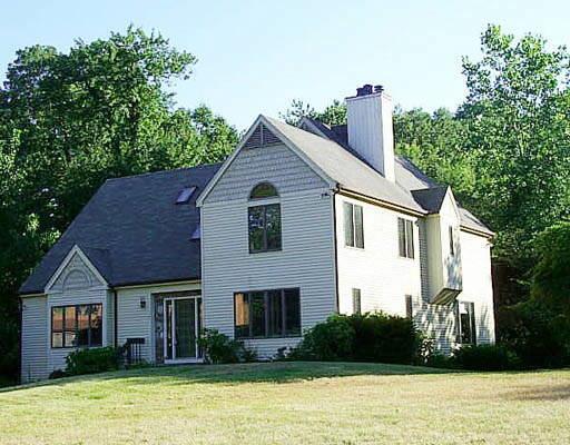 a view of a house with pool and plants