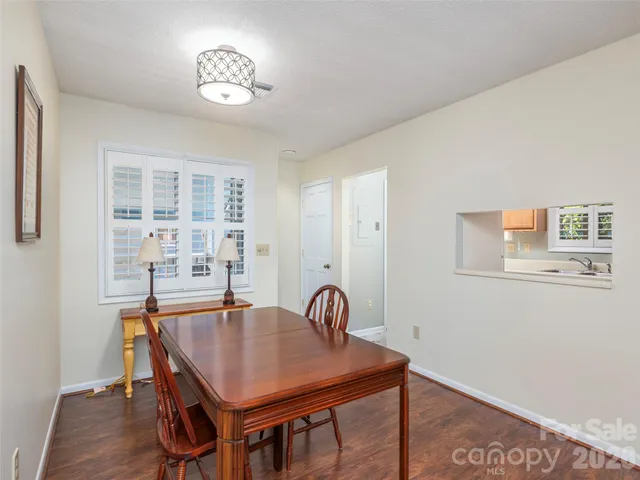 a view of a room that has a table and chairs