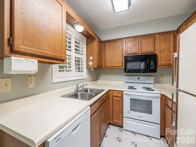 a kitchen with a sink a stove and microwave