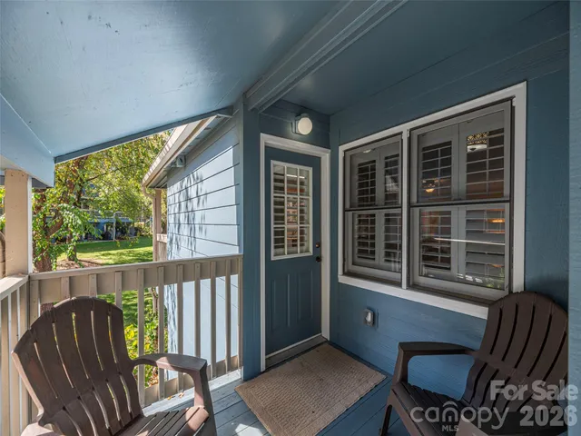 a view of a porch with furniture and a yard