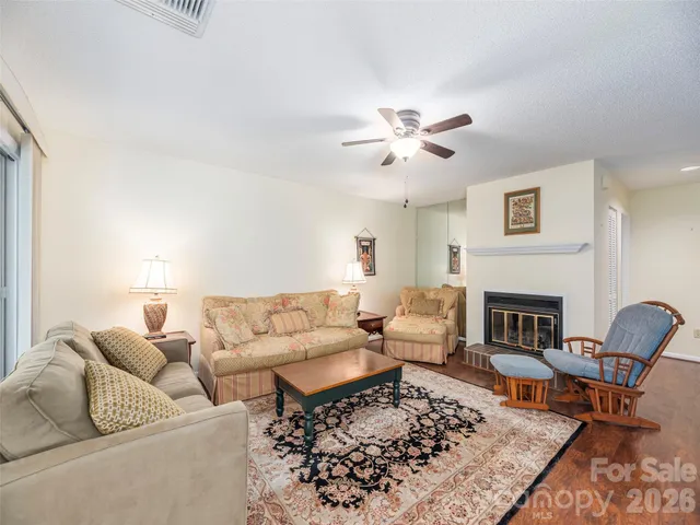 a living room with furniture a fireplace and a table