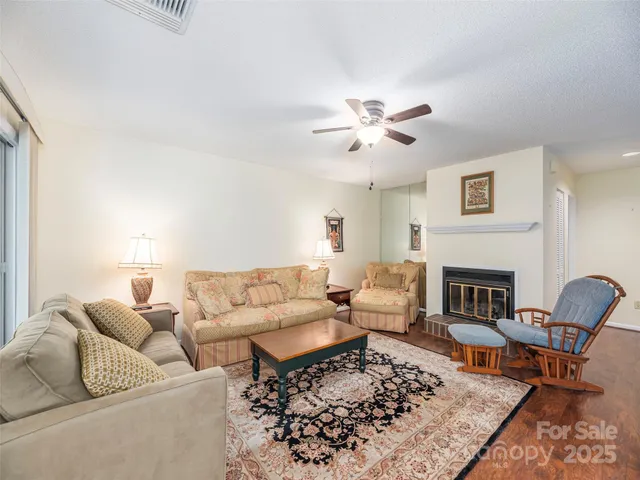 a living room with furniture a fireplace and a table