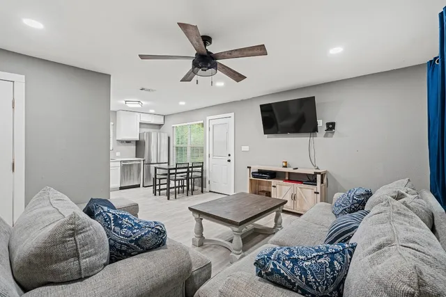 a living room with furniture and a flat screen tv