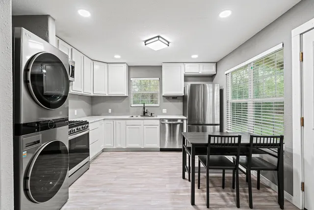 a kitchen with a stove a sink and a refrigerator
