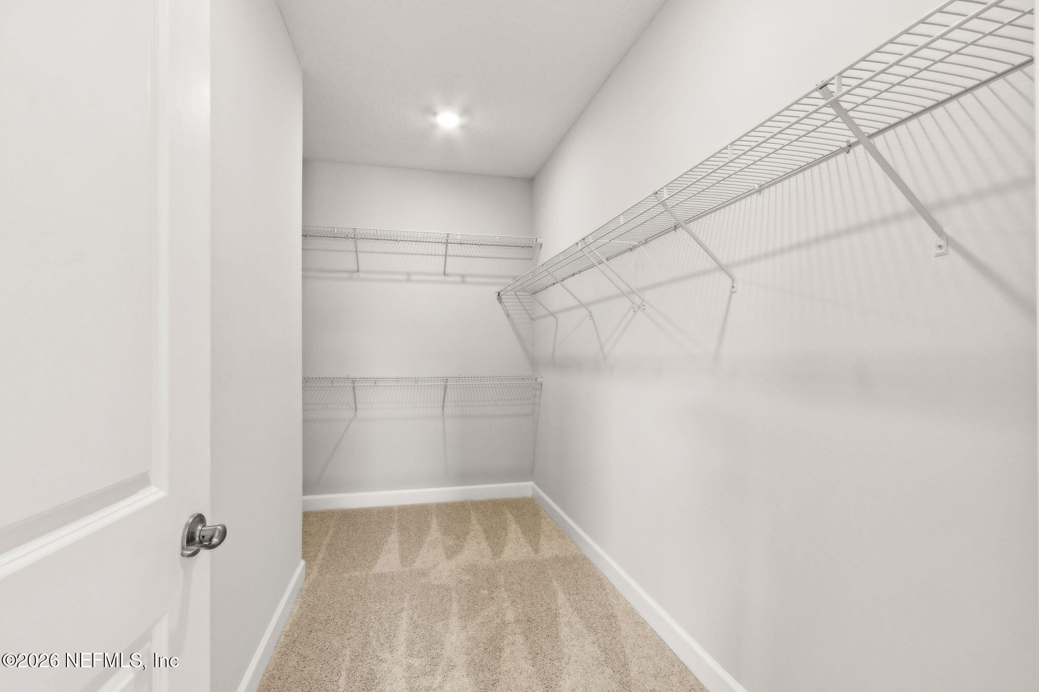 85236 Sandy Rdg Loop, Unit 26 Yulee, FL 32097 - Photo 10 of 17 a view of a room with racks on the wall