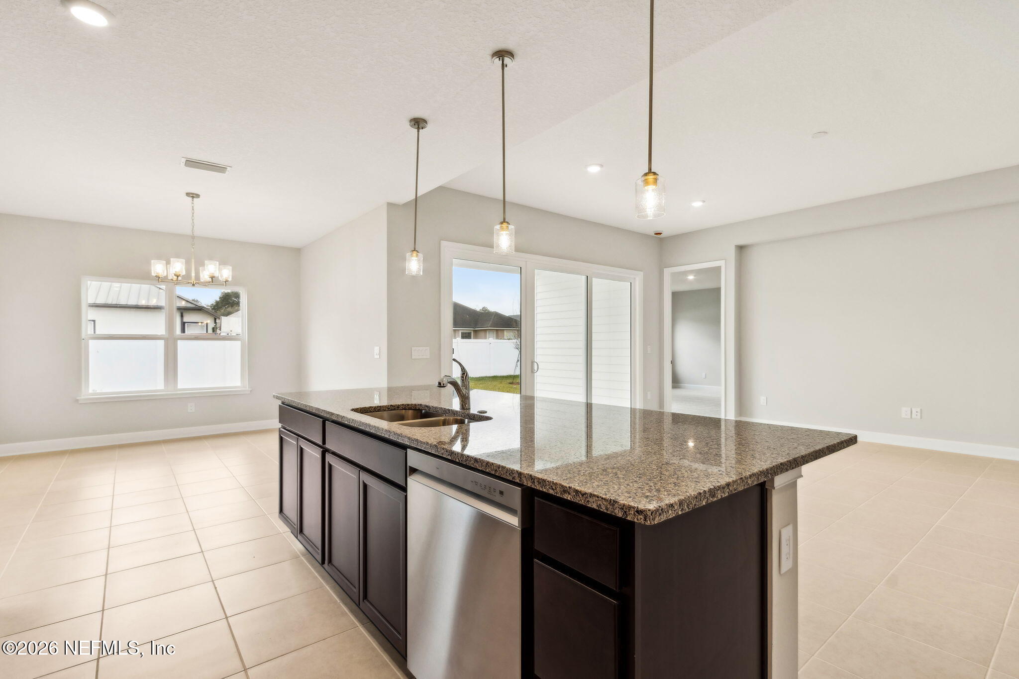 85236 Sandy Rdg Loop, Unit 26 Yulee, FL 32097 - Photo 5 of 17 a kitchen with granite countertop a sink a stove and refrigerator
