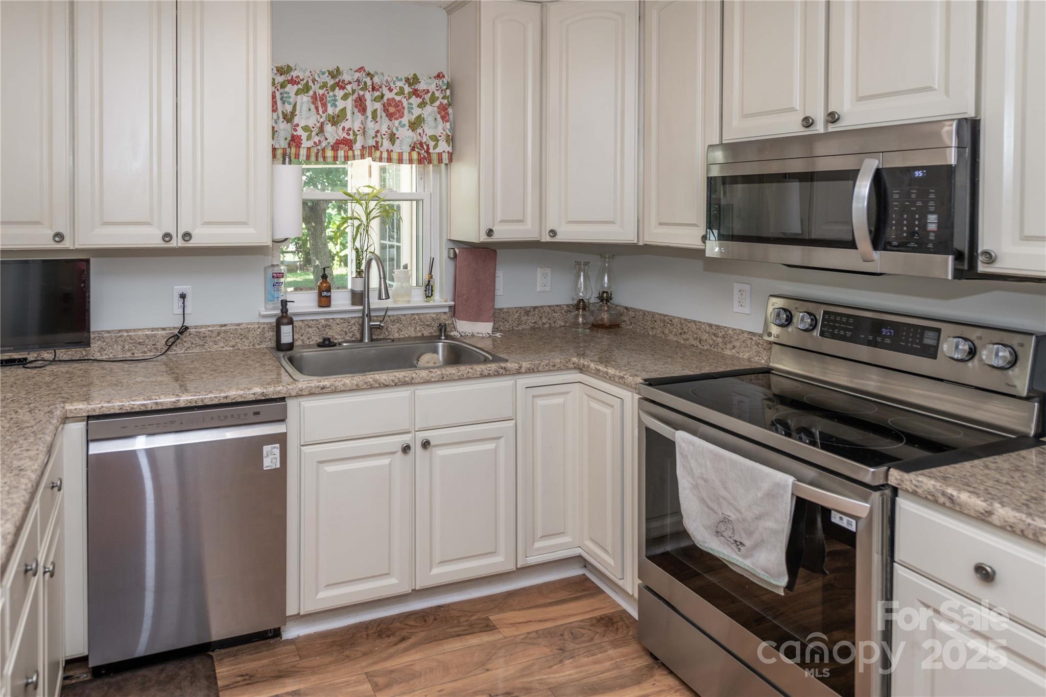 2085 Chapel Creek Road Concord, NC 28025 - Photo 13 of 47 a kitchen with granite countertop a sink cabinets and stainless steel appliances