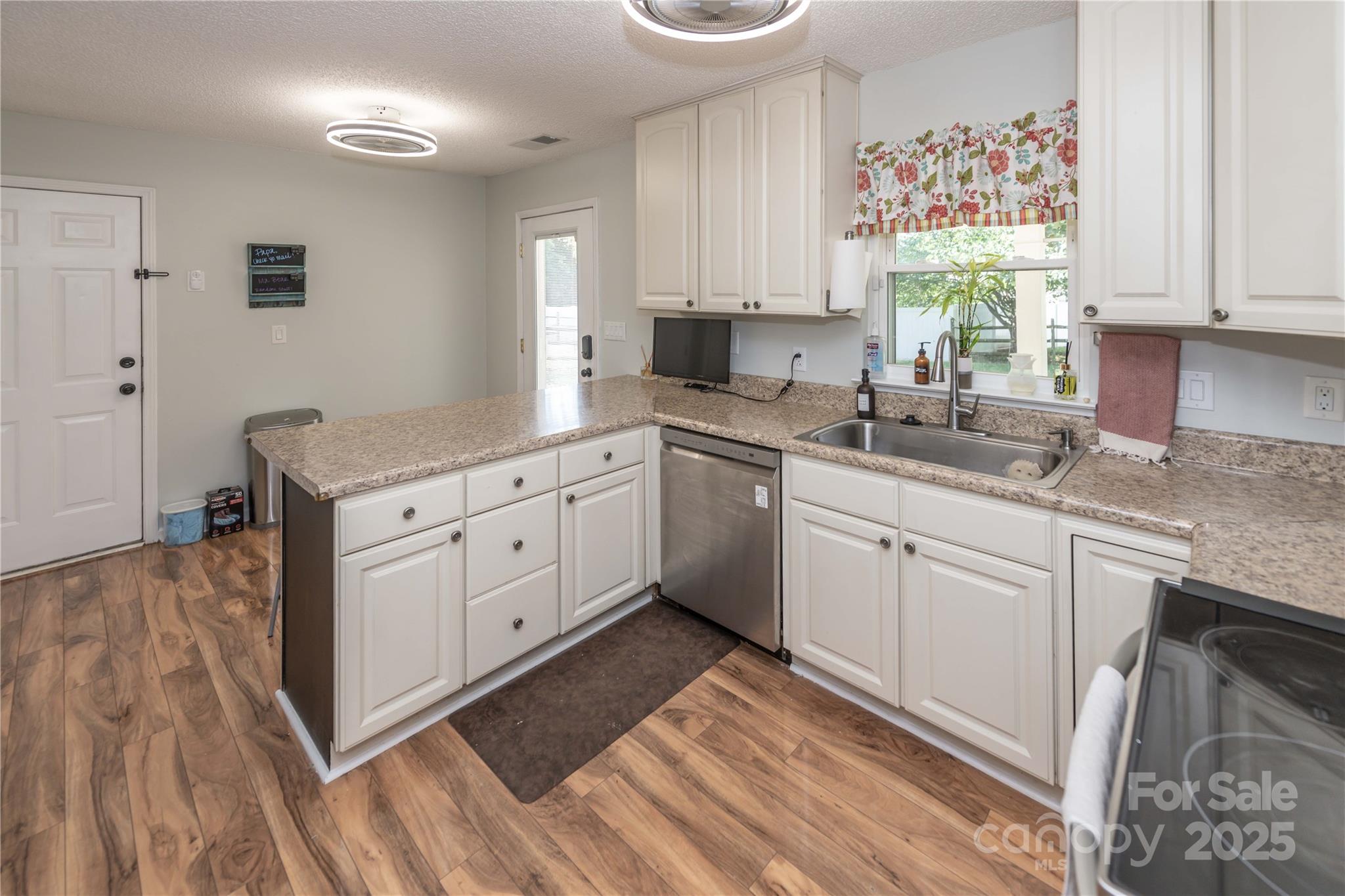 2085 Chapel Creek Road Concord, NC 28025 - Photo 14 of 47 a kitchen with granite countertop white cabinets and white appliances