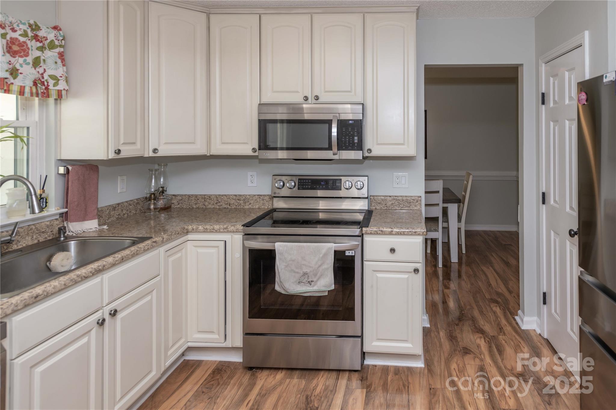2085 Chapel Creek Road Concord, NC 28025 - Photo 15 of 47 a kitchen with stainless steel appliances granite countertop a stove microwave and refrigerator