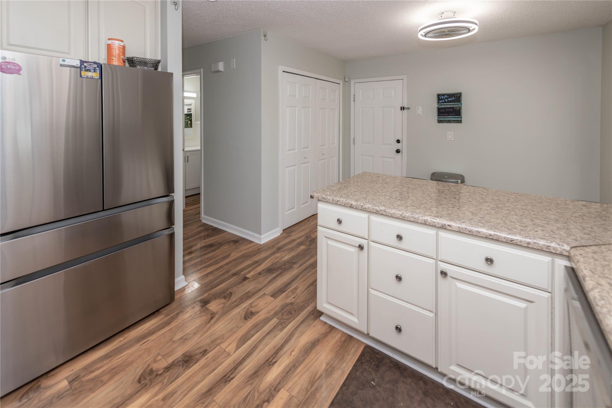 2085 Chapel Creek Road Concord, NC 28025 - Photo 16 of 47 a kitchen with a refrigerator and countertop white cabinets