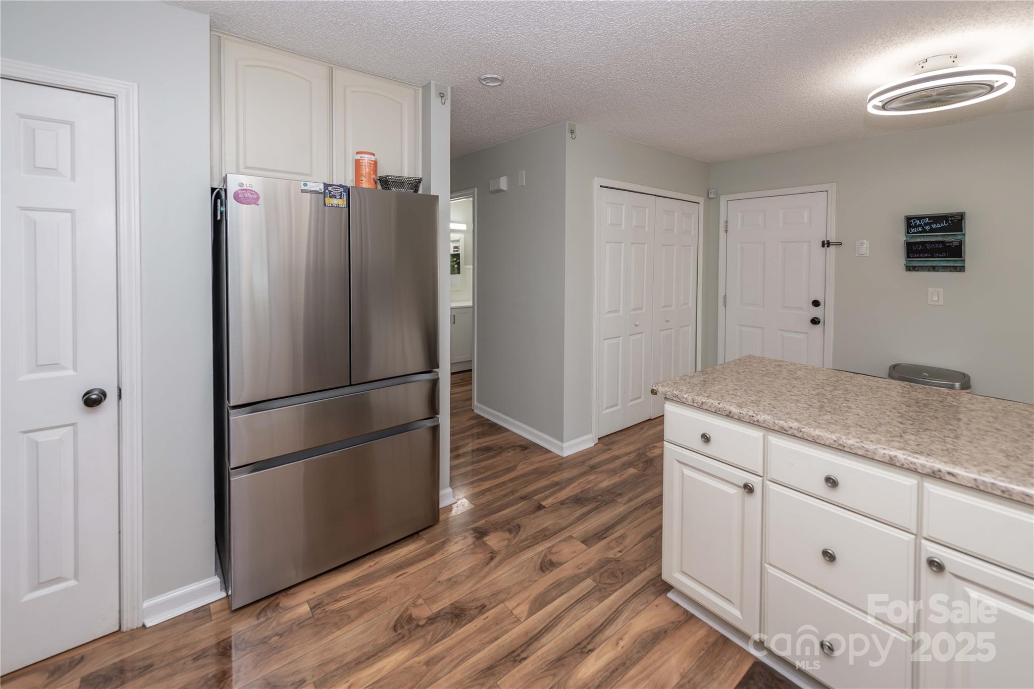 2085 Chapel Creek Road Concord, NC 28025 - Photo 17 of 47 a kitchen with cabinets stainless steel appliances and wooden floor