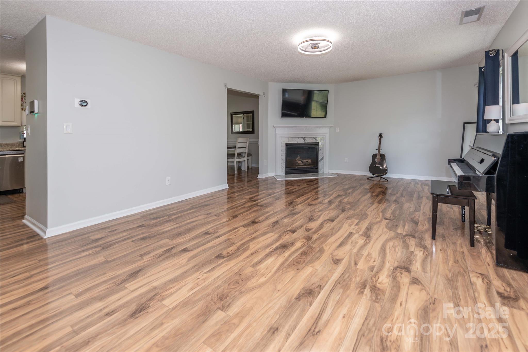 2085 Chapel Creek Road Concord, NC 28025 - Photo 3 of 47 a view of empty room with wooden floor and fireplace