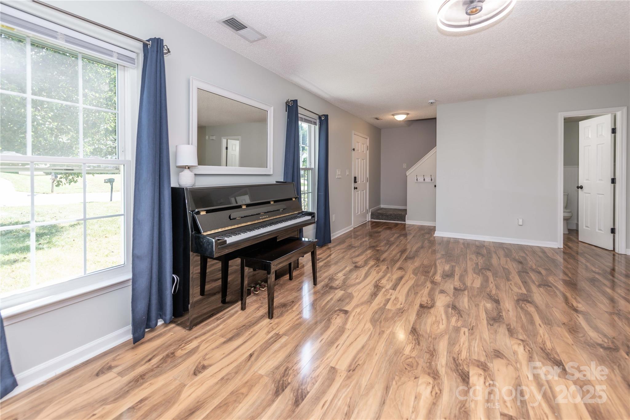 2085 Chapel Creek Road Concord, NC 28025 - Photo 6 of 47 a view of an empty room with wooden floor and a window